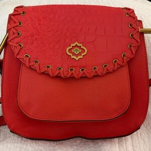 orYANY orange leather crossbody bag with whipstitching.